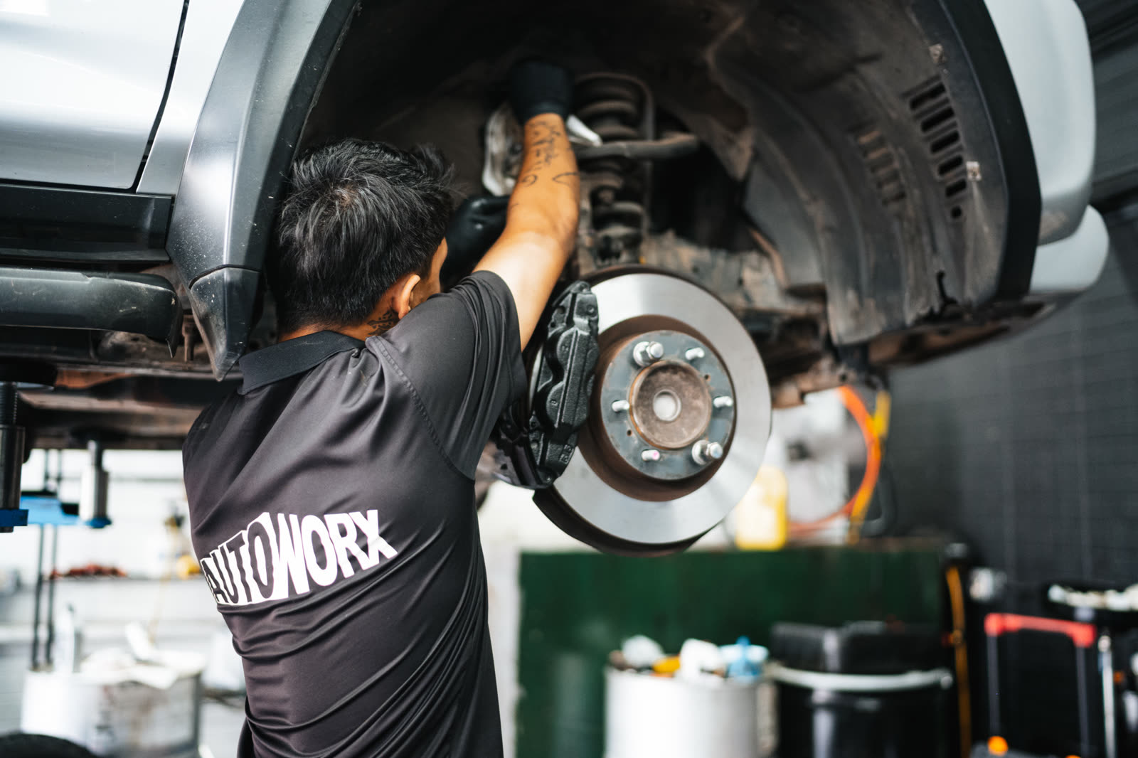 AutoWorx technician performing brake service